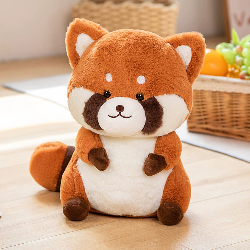 Plush toy red panda on a wooden floor with a basket of fruits in the background