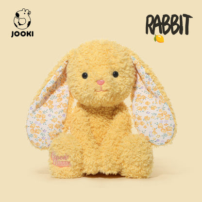 Plush rabbit toy with floral ears on a beige background, featuring the brand 'Jooki'.