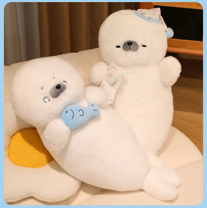 Two white seal plush pillows resting together on a sofa