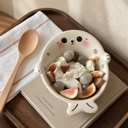 Seal-shaped bowl with dessert, fruit and wooden spoon