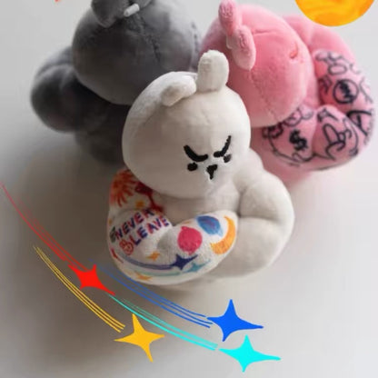 White Muscle Rabbit Coach plush bag charm shown in front with grey and pink versions behind