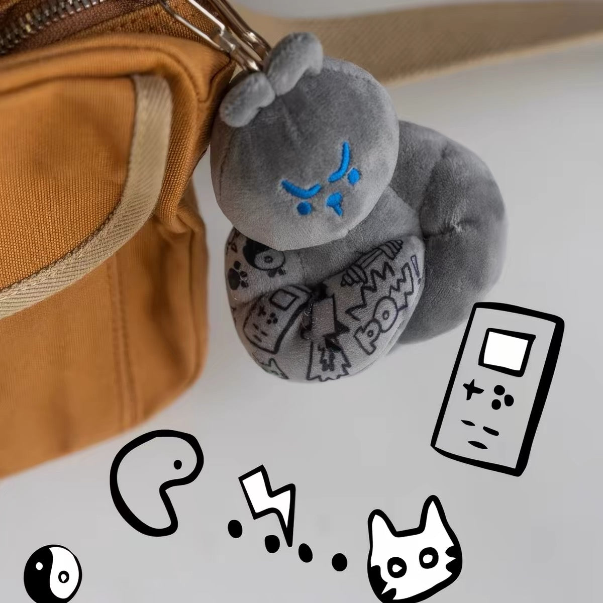 Grey Muscle Rabbit Coach plush bag charm attached to a bag