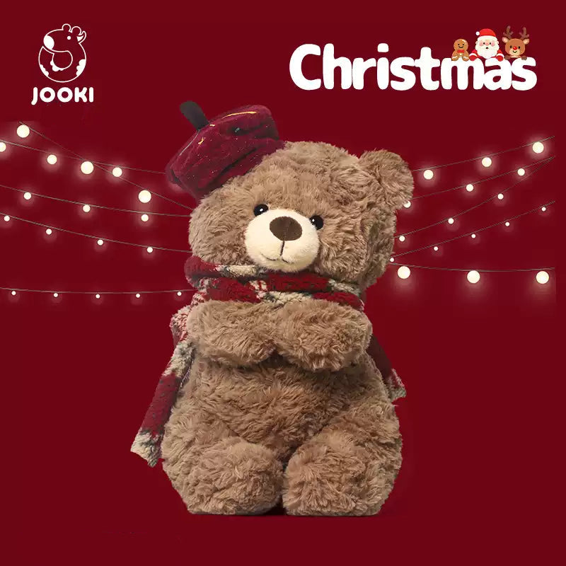 Brown teddy bear wearing a red hat and scarf on a red background with Christmas lights, 