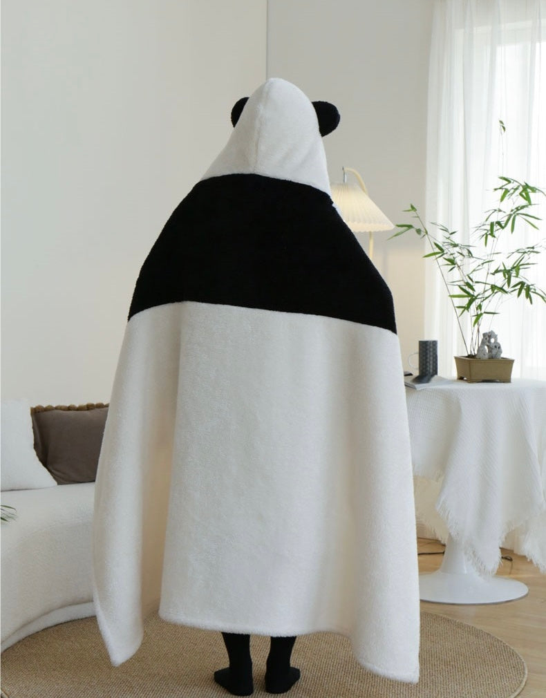 Person wearing a panda-shaped towel in a living room setting
