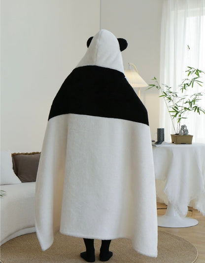 Person wearing a panda-shaped towel in a living room setting