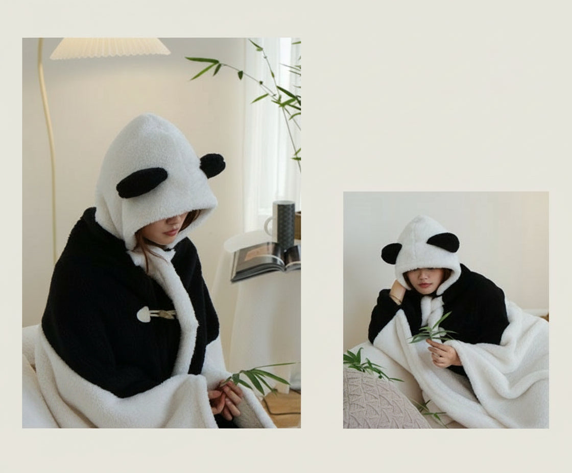 Person wearing a panda-themed hooded blanket in a cozy indoor setting.