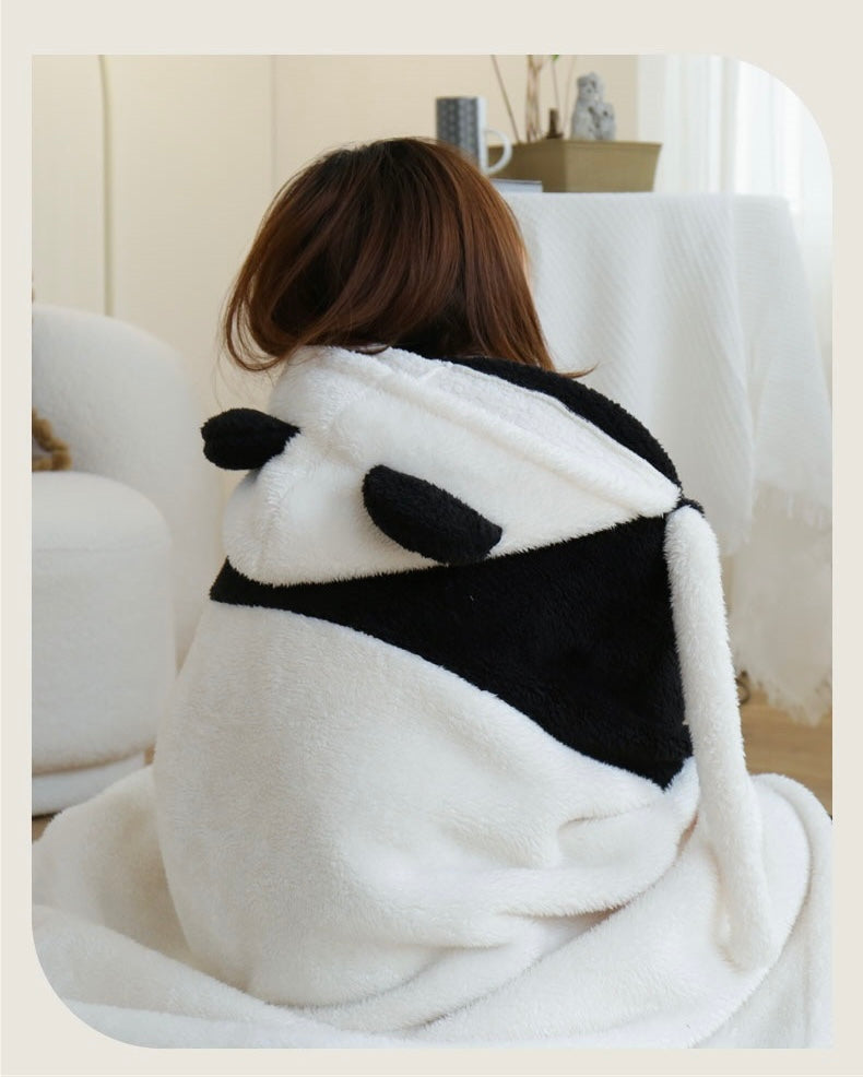 Person wrapped in a panda-shaped blanket on a couch