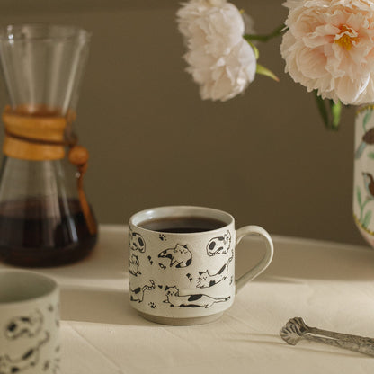Ceramic mug with animal prints on a table with coffee and flowers