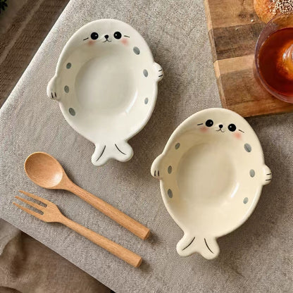 White and cream Chubby Seal ceramic bowl set with two wooden spoon and fork sets