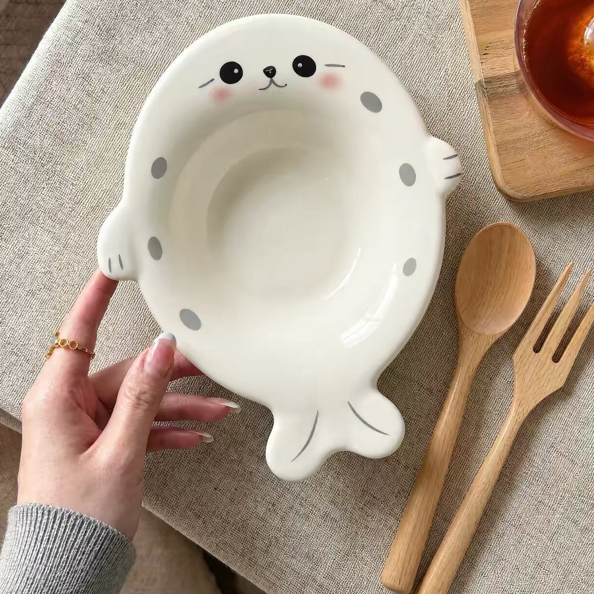 White Chubby Seal ceramic bowl with wooden spoon and fork
