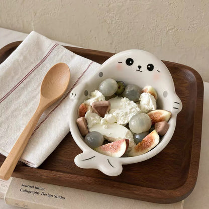 White Chubby Seal ceramic bowl with wooden spoon