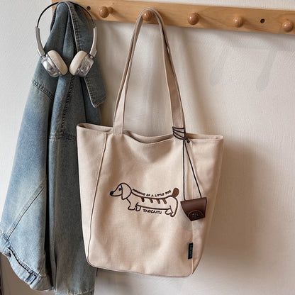 Beige grey embroidered dachshund tote bag hanging on wall hook